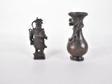 deux vases posés l'un à côté de l'autre sur une surface blanche