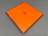 a close up of an orange box sitting on a table