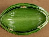 a green bowl that is sitting on a table