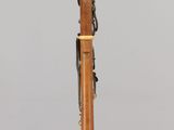 an image of a wooden instrument on a stand on a gray surface