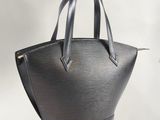 a close up of a black handbag on a white background