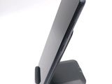 a cell phone on a stand on a white surface