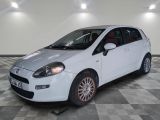 a picture of a small white car parked in a garage