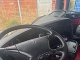 a steering wheel and dashboard of a red tractor