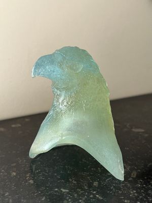 a glass sculpture of a wave on a table