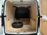 a white van that has a tire in the back of it