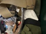 a green trash can filled with assorted items