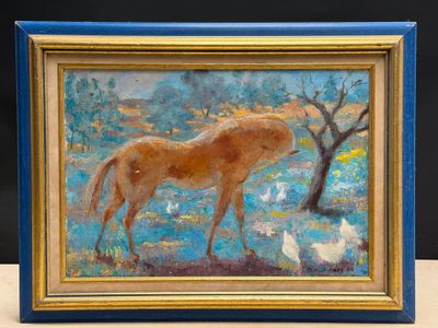 a painting of a horse in a blue frame on a table