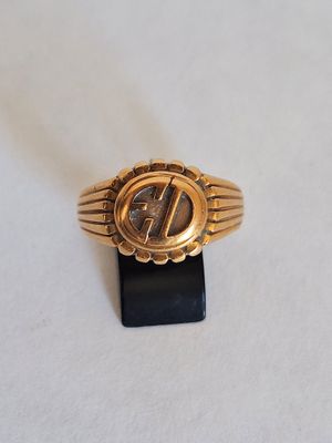 a close up of a gold ring on a white surface