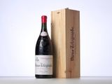 a bottle of wine sitting next to a wooden box