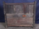 an old wooden bed frame with a metal latch on top of it