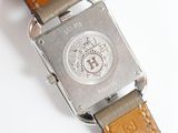 a close up of a watch on a white surface