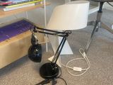 a lamp that is sitting on the floor next to a chair