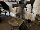 a machine that is sitting in a garage with other tools