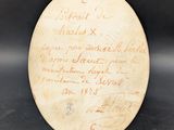 an old piece of paper with writing on it sitting on a table