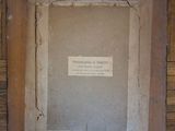 an old picture of a picture frame on a wooden wall