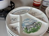 a white plate with a picture of a cow on it