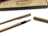 a close up of a pen and two other items in a box