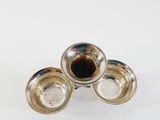 silver plated candlestick holders on a white surface with a white background