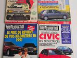four magazines of different cars on display on a white surface