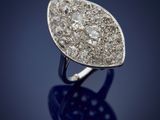 a close up of a diamond ring on a blue surface