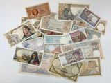 a lot of different foreign currency on the table