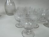 a lot of wine glasses and a pitcher on the table