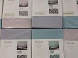 several sheets of bedding are stacked on top of each other