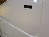 a small sticker on the hood of a white car