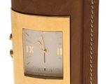brown leather watch case with gold plated face and roman numerals