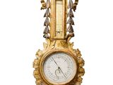 a gold clock sitting on top of a marble table