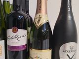 bottles of wine are lined up on a white surface