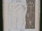 framed drawing of a woman hugging a man in front of a wall