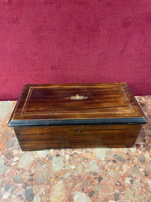 an old wooden box sitting on top of a marble floor