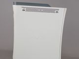 the back side of a white computer with a grey background
