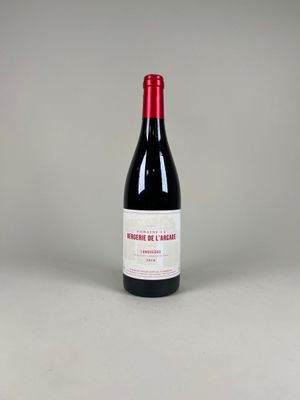 the bottle of red wine is sitting on the table