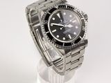 an image of a rolex watch on a stand on a white surface