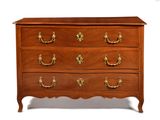 an antique chest of drawers with brass handles and a wooden top