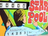 a close up of a pinball machine with a woman on it