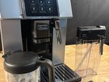 a coffee maker and blender sitting on a wooden table