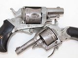 two revolvers that are sitting on a white surface