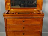 an old wooden dresser with a mirror on top of it