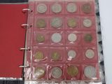 a lot of coins in a plastic case on top of a table