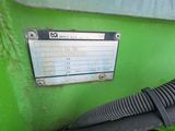 a close up of a green machine with a hose attached to it
