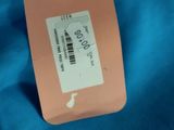 the label is attached to a blue shirt with a pink ribbon