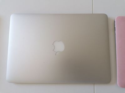 two laptops that are sitting next to each other on a table