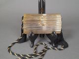 an image of a gold and black purse with tassels