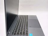 a silver laptop with a black keyboard on a white surface