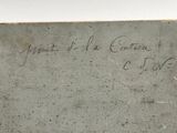 an old piece of paper with writing on it sitting on top of a table