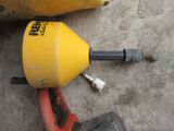 a yellow and black object on the ground next to a yellow and black object